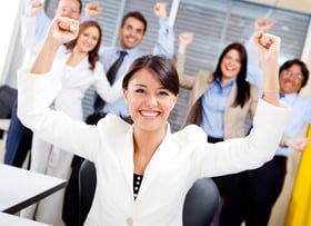 Business woman with arms up leading a successful team