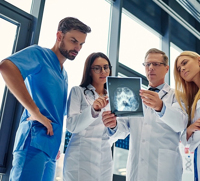 doctor with nurses reviewing scan