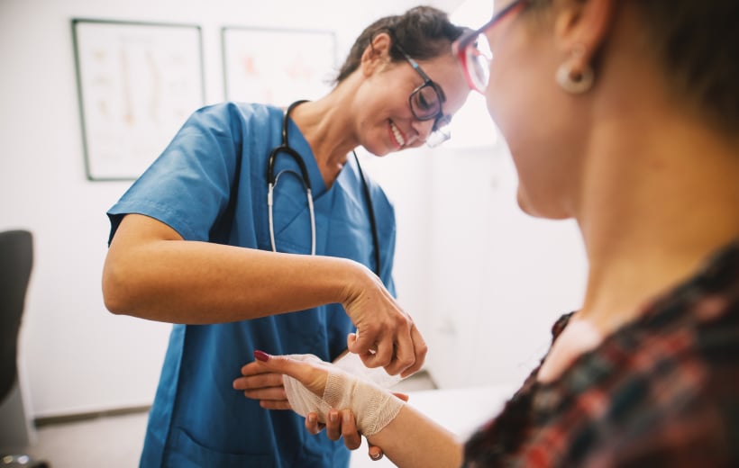 smiling-nurse-helping-patient-landscape