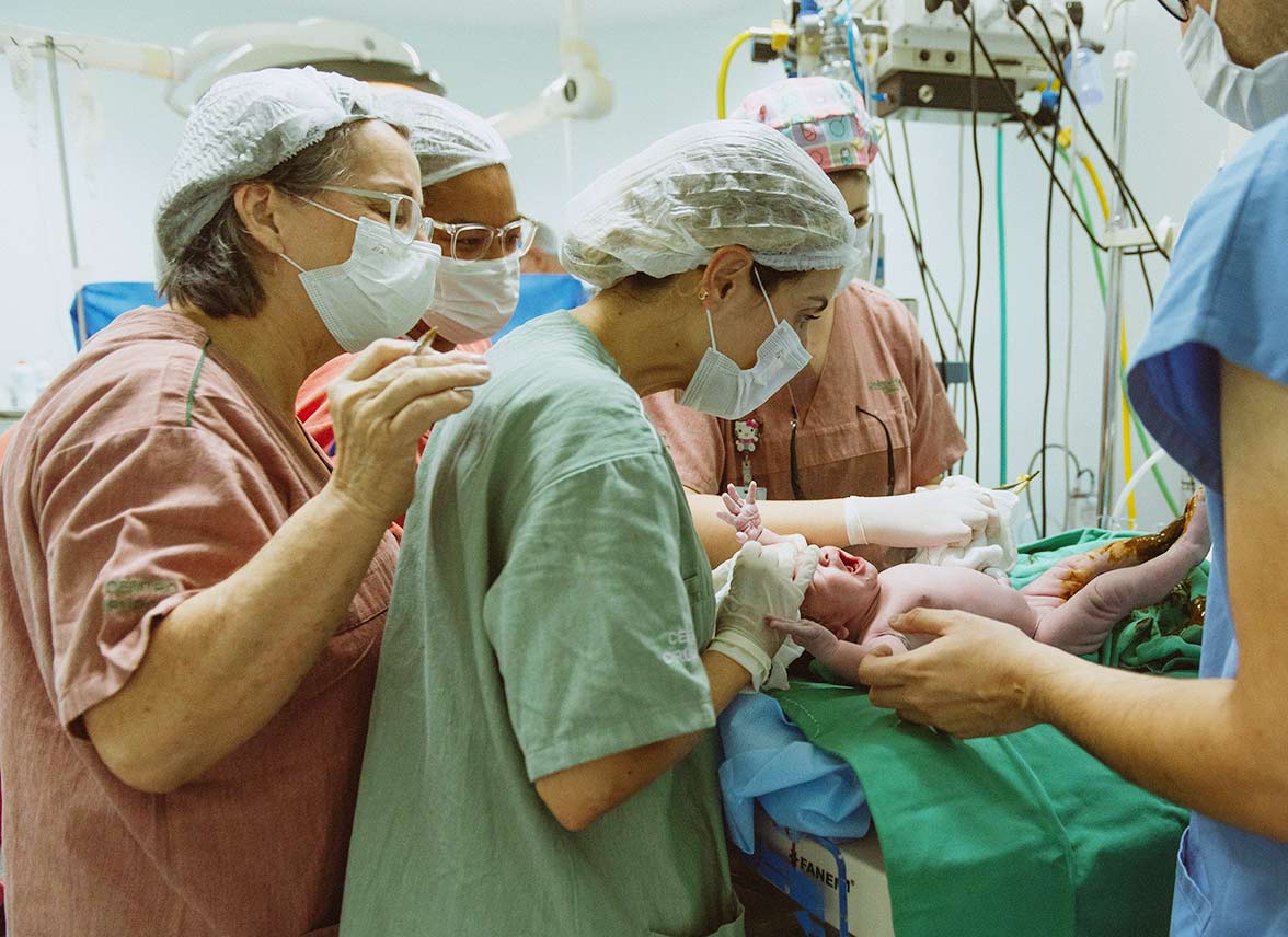 Nurses caring for newborn at birth.